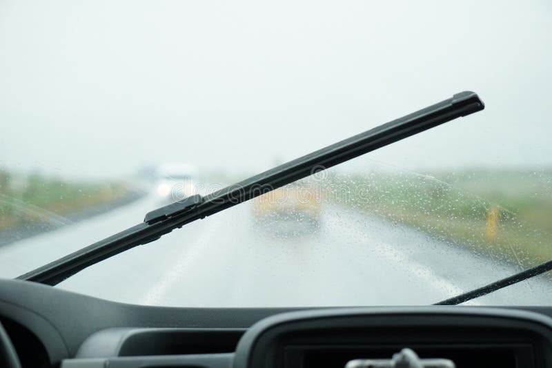 Driving a Car in the Rain with Activated Windshield Wipers Stock Image