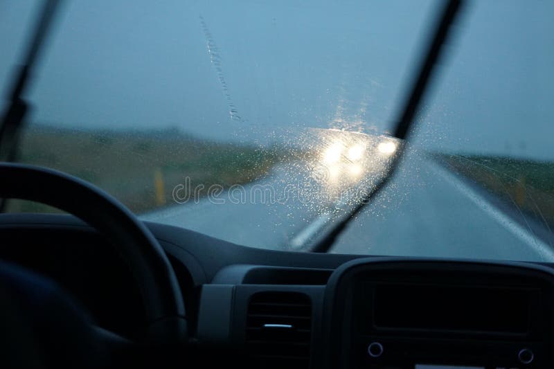 Driving a Car in the Rain with Activated Windshield Wipers Stock Image