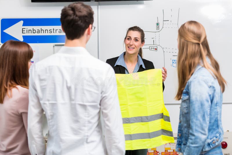 Driving instructor explain the importance of a safety vest stock photography Driving instructor explain the importance of a safety vest stock photography