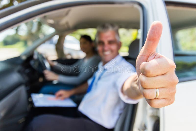 Driving instructor thumb up royalty free stock image