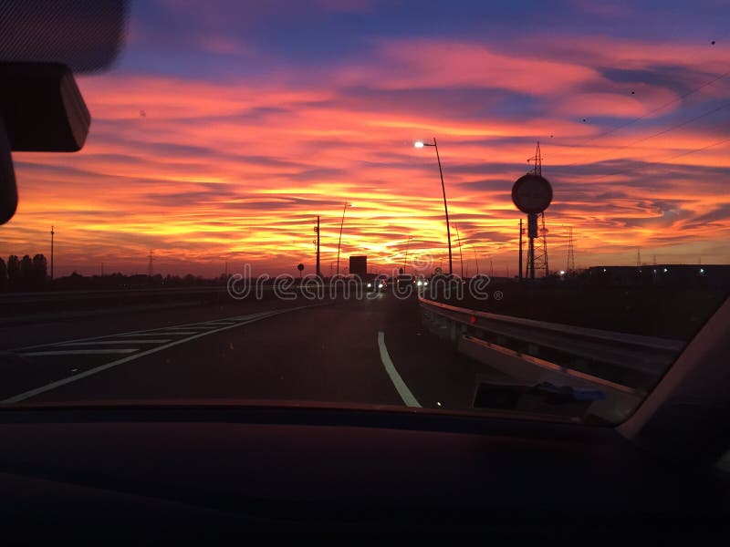 Driving sunset. While driving towards home a beautiful sunset stoned in front of my eyes. Superb, colourful, magnificent