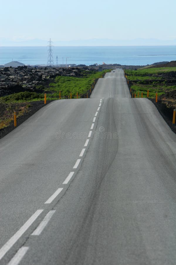 Curvy road in lava heading towards the sea. Curvy road in lava heading towards the sea