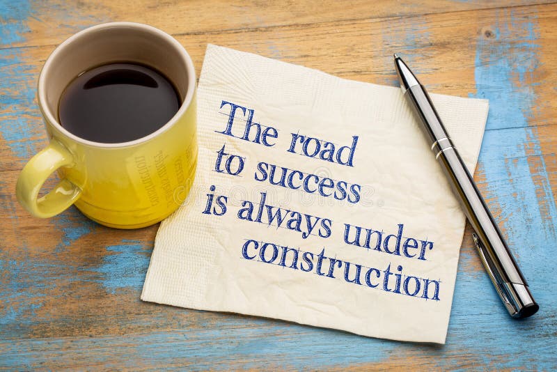 The road to success is always under construction - handwriting on a napkin with a cup of espresso coffee. The road to success is always under construction - handwriting on a napkin with a cup of espresso coffee