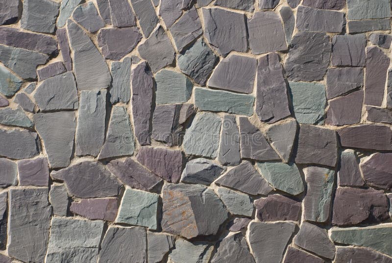 A thick textured slate or shale rock wall or path in a crazy random pattern. A thick textured slate or shale rock wall or path in a crazy random pattern