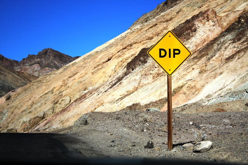 Speed limit sign with dip in a mountain. Speed limit sign with dip in a mountain