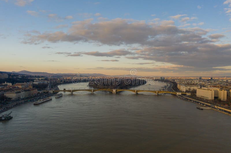 Aerial drone shot of Margaret Bridge over Danube river in Budapest sunset hour in winter. Aerial drone shot of Margaret Bridge over Danube river in Budapest sunset hour in winter