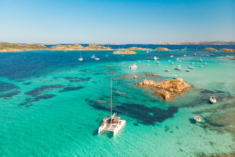 Drone aerial view of catamaran sailing boat in Maddalena Archipelago, Sardinia, Italy.