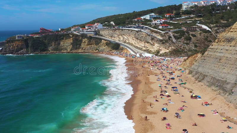 Drone capturing scenic Magoito Beach with town on cliff during daytime stock video footage