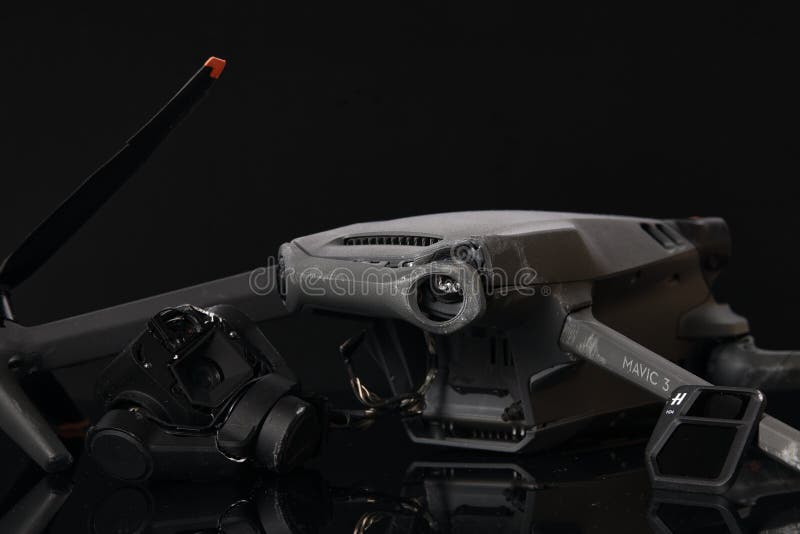 Drone DJI Mavic 3 after crashed on a black background. Drone after falling from a height. Broken gimbal camera and drone stock images
