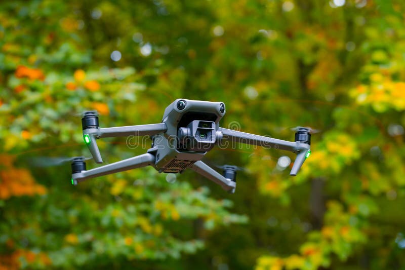 Drone flying in air photography and videography technological device system with wing propellers and gimbal camera details close royalty free stock image