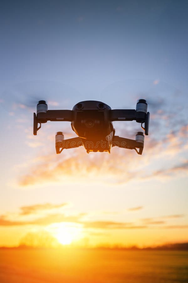 Drone flying on sunset stock photo