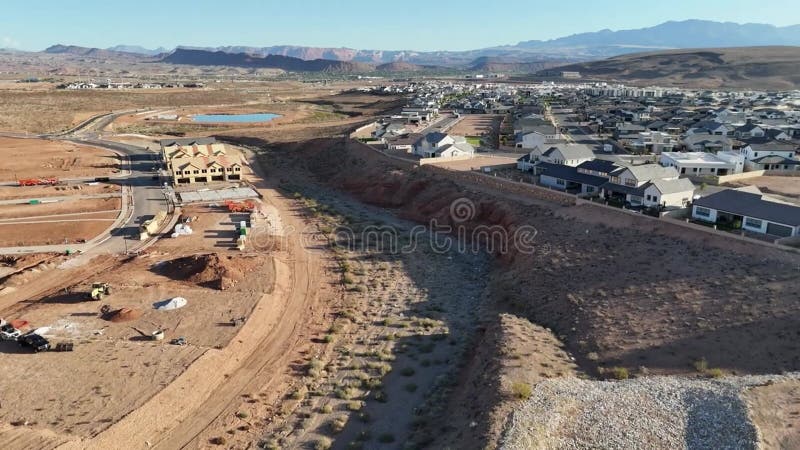 Drone footage of desert landscape with construction site and residential community on a sunny day stock footage