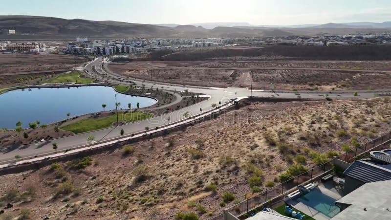 Drone footage showcasing modern residential communities with artificial lake in St George, Utah stock video footage