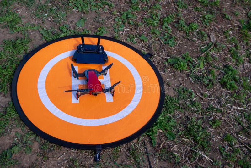 Furnace bleg Mathis Drone on the Heliport. Drone Phone and Control Panel on an Orange Helipad  on the Grass Editorial Photo - Image of flying, helicopter: 152663206