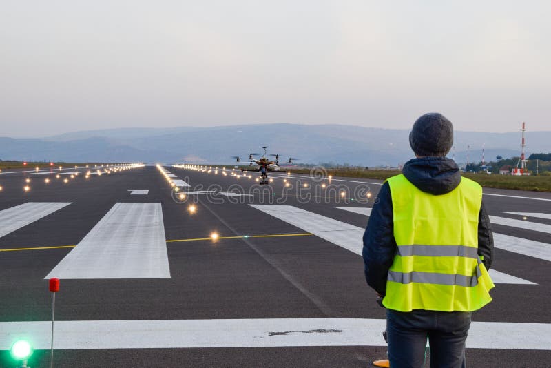 Drone inspection over airport runway with operator