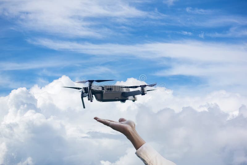 The Drone and Photographer Human Hand. Drone Copter Flying with Digital