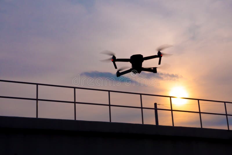 Drone quadcopter flying at sunset stock photos