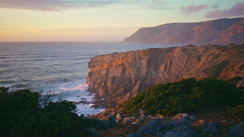 Drone scenic coast landscape in sunset light. Ocean waves crashing rocky terrain