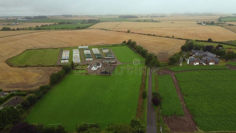 Drone view of the farmland and the caravan of farm workers. stock footage