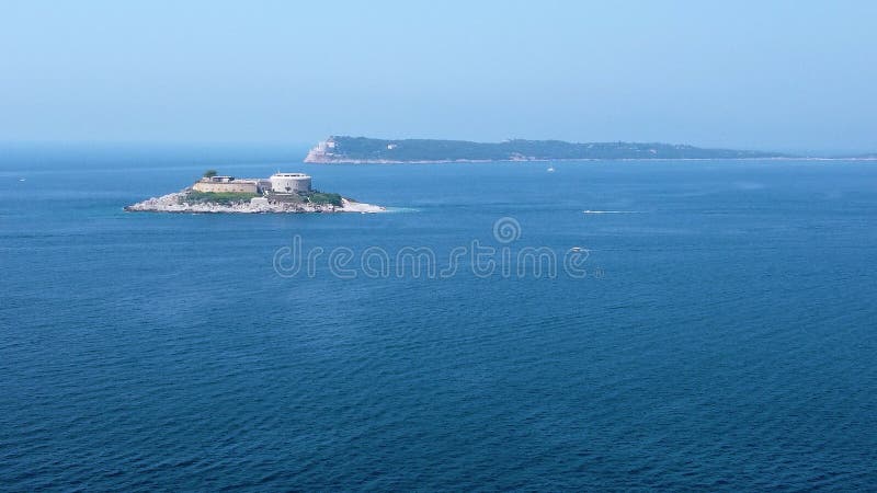 Drone view of the former concentration camp In Montenegro in the middle of the blue water stock footage