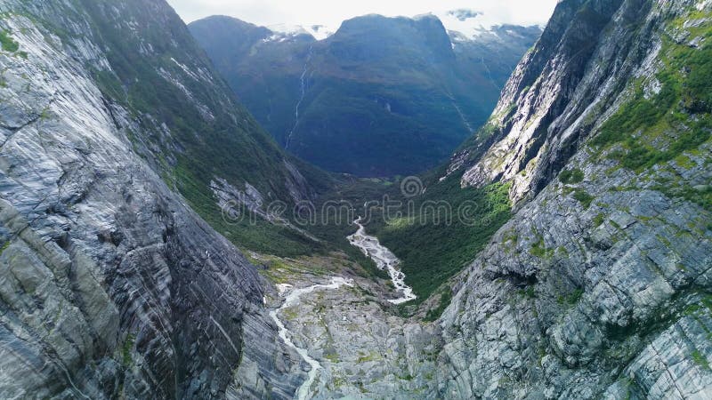 Drone view of glacial meltwater and streams through rugged rock formation in Brenndalsbreen, Norway stock video