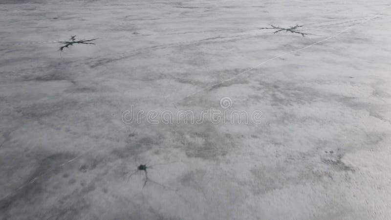 Drone view on ice on the lake or river. Cracking and melting ice on water.