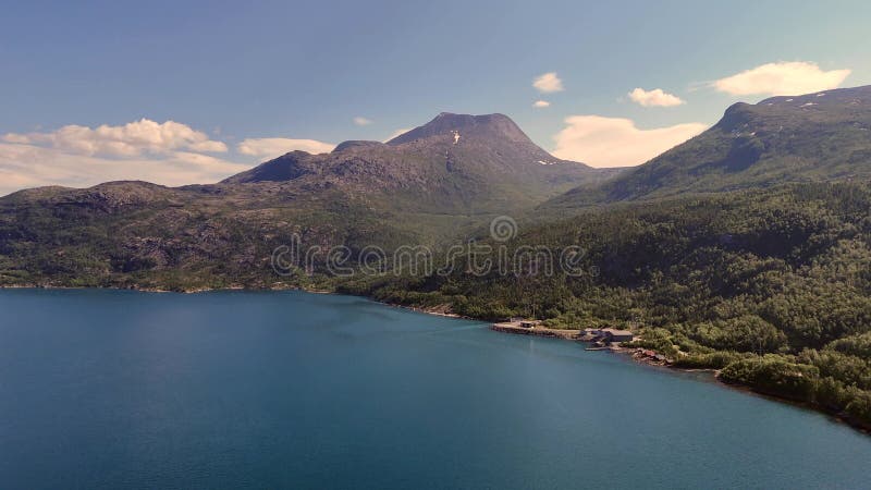 Drone view sweeping over the deep blue water of Rombaksbotn bay stock video