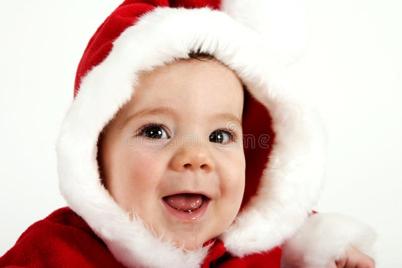 Baby boy dressed in red Santa coat and hood trimmed in white fur. Baby boy dressed in red Santa coat and hood trimmed in white fur.