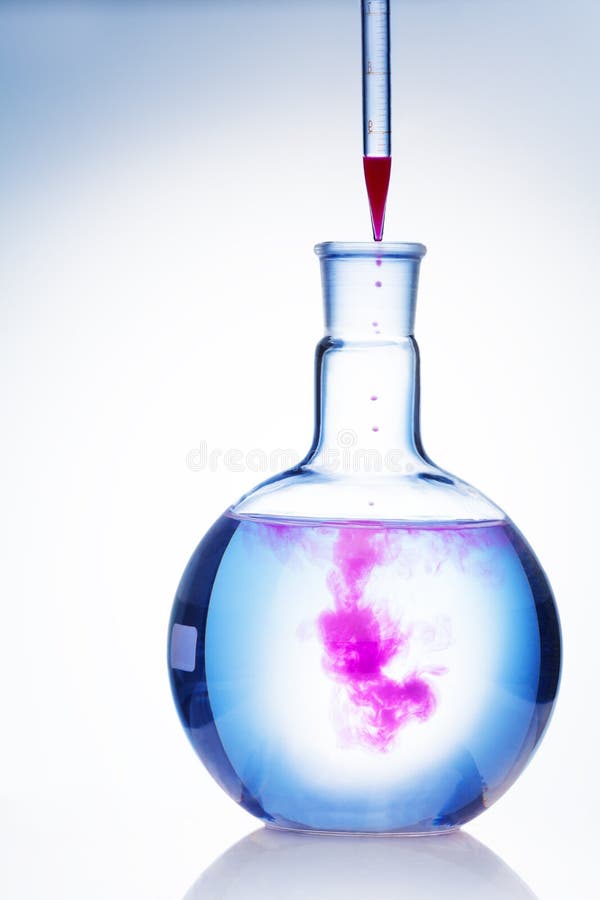 Drop of color in flask stock photo