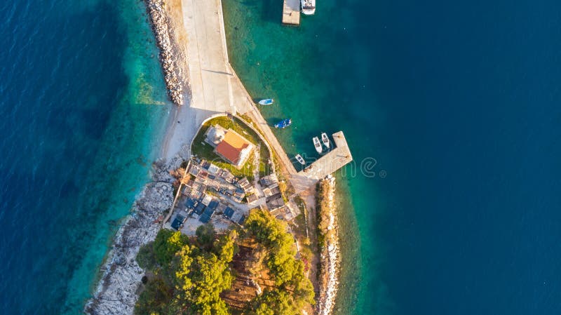 Drop down view of coastal village at sunset.