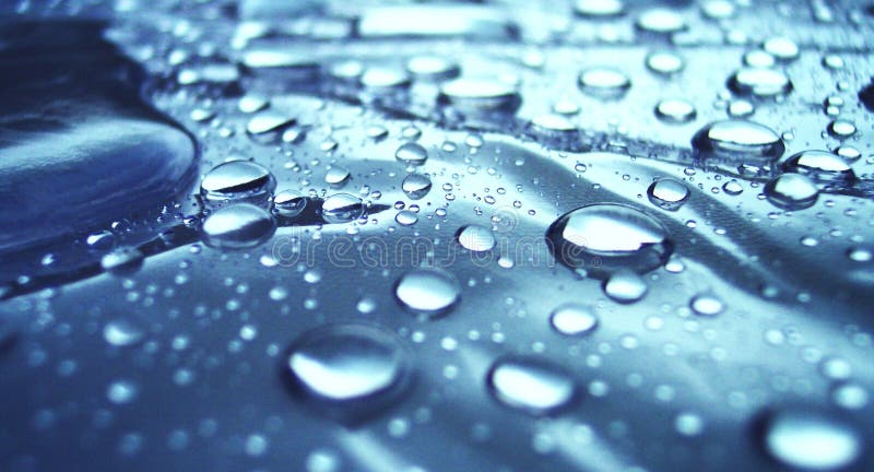 Drops reflecting sunlight on a structured underground. Metal n stock images, royalty-free photos and pictures