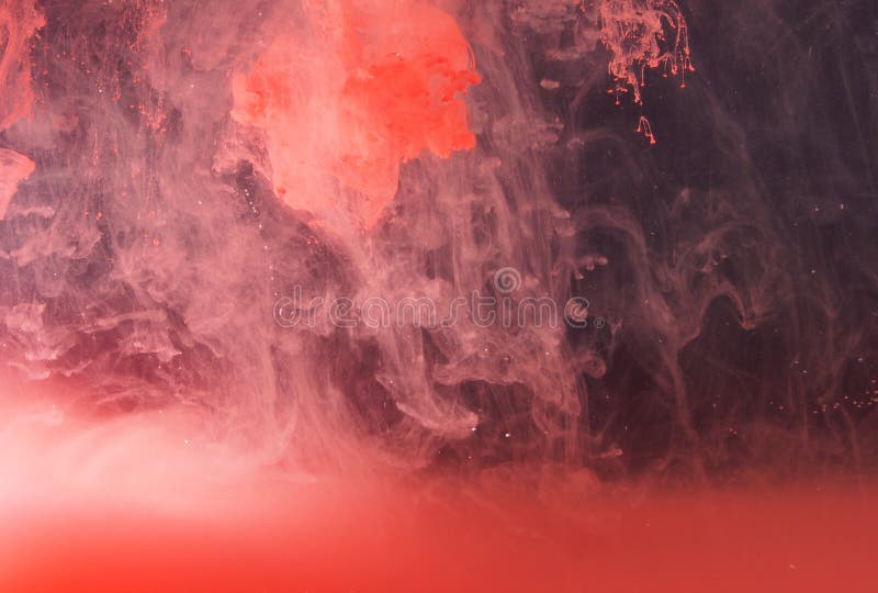 A Drop of Paint Dissolves in Water. Red Paint is Mixed with Water Stock