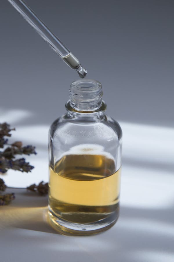 Drop on a Pipette Over Glass Dropper Bottle with Skin Care Cosmetic