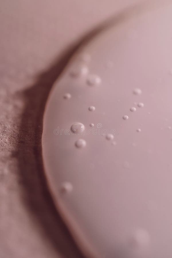A drop of shampoo on a pink background. stock photography
