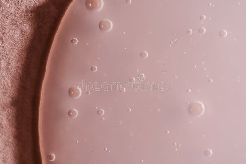 A drop of shampoo on a pink background. stock photos