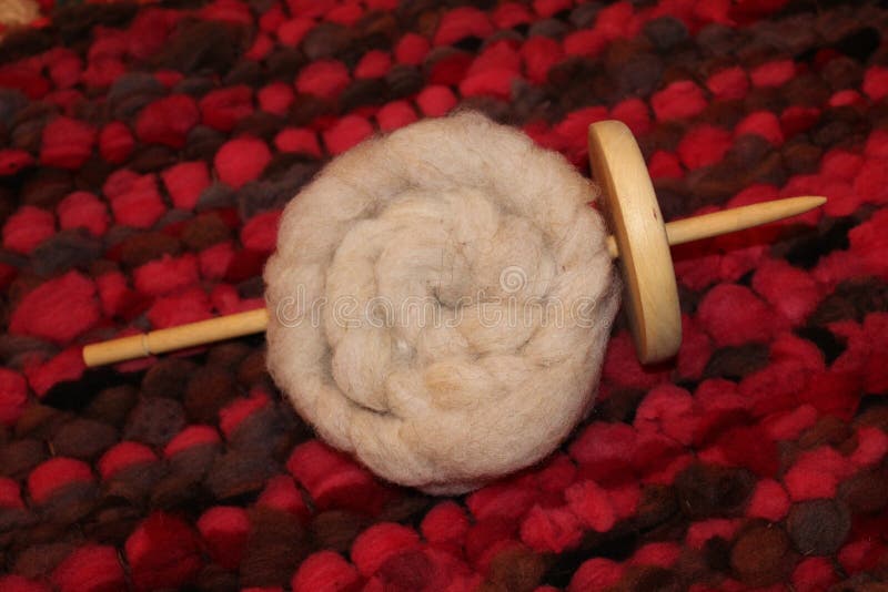 Drop spindle with sheep wool roving