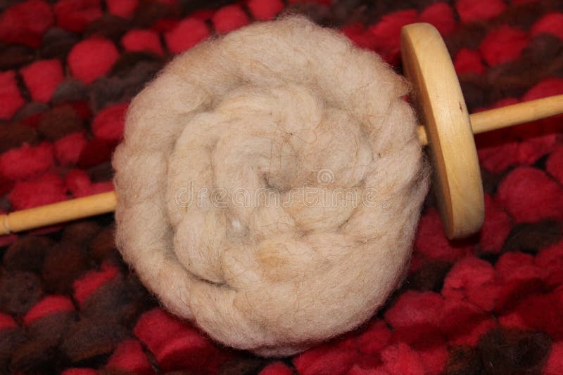 Drop spindle with sheep wool roving