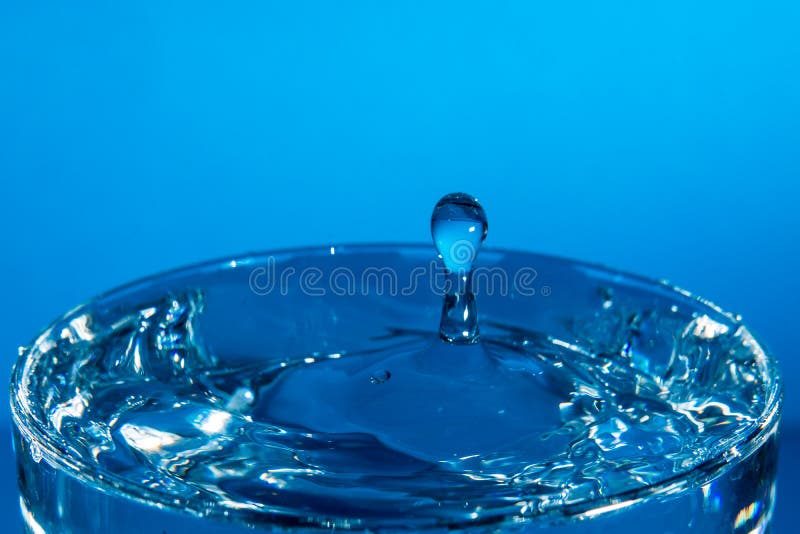 Drop of Water Falling into a Glass, Hitting Water Surface.Selected