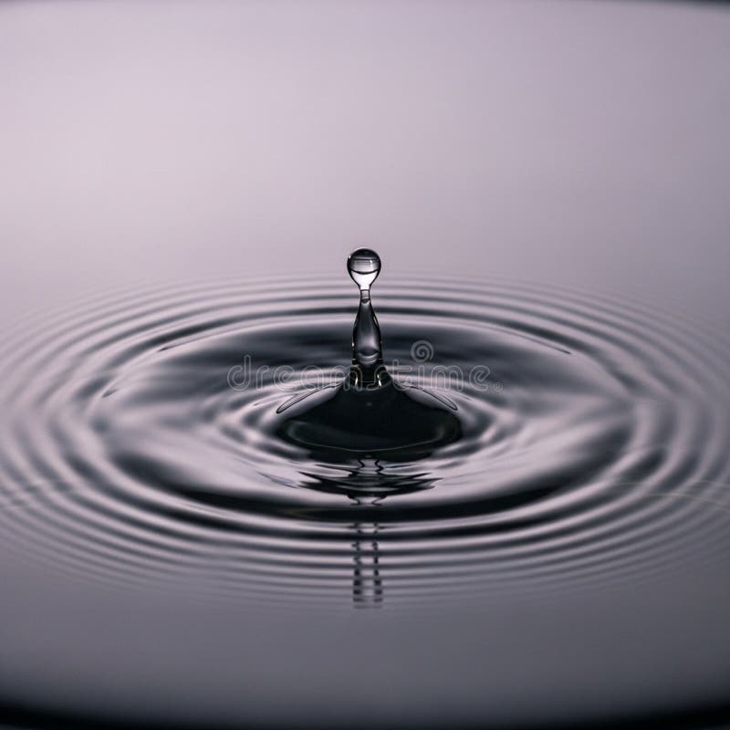 Droplet is suspended mid-air, forming a crown-like splash pattern stock illustration