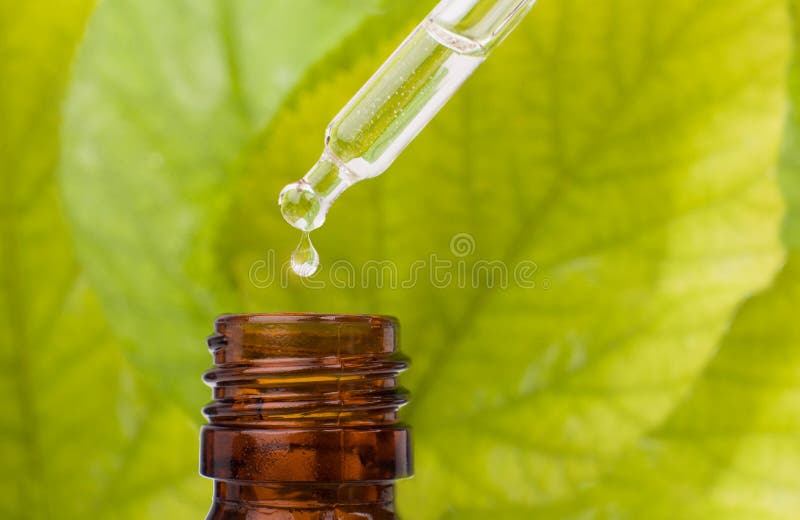 Dropper over essential oil bottle. stock image Dropper over essential oil bottle. stock image