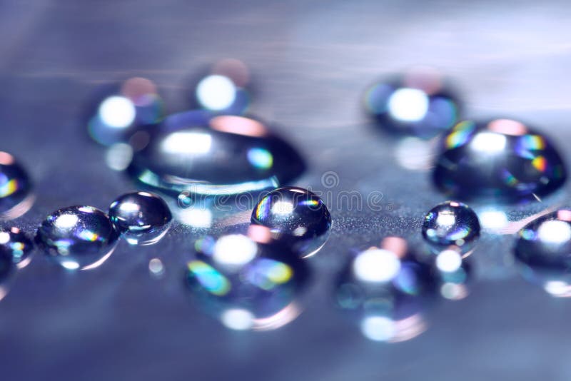 Drops on the glass with reflection. Abstract macro with colorful drops. stock images