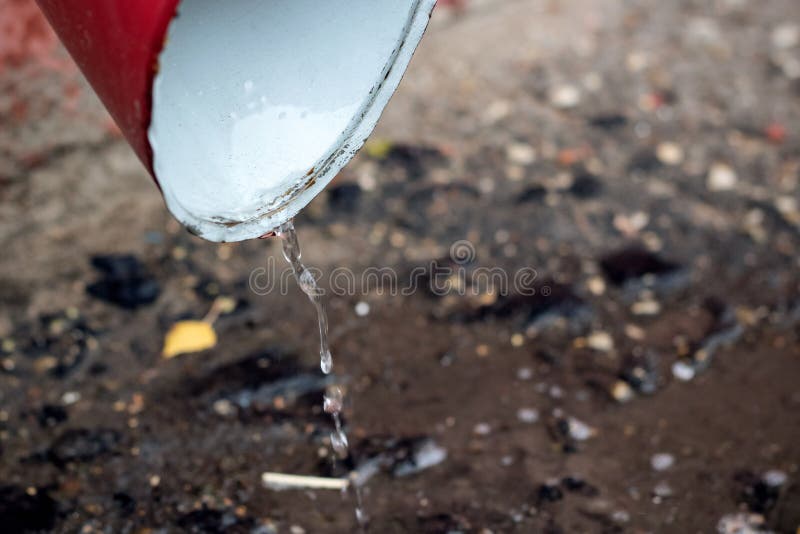 Drops of water fall from the rain drain pipe stock photography Drops of water fall from the rain drain pipe stock photography