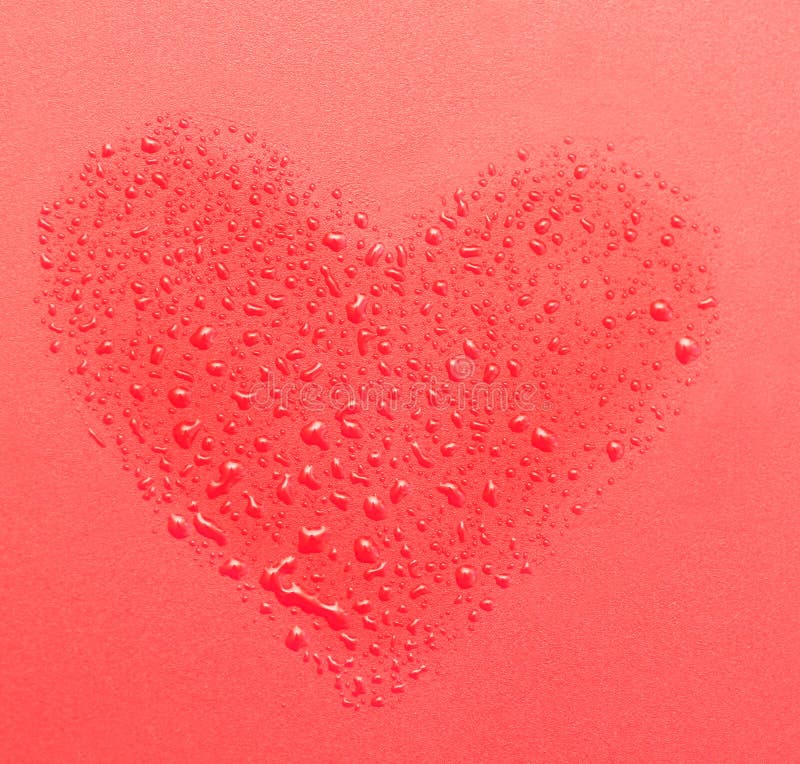 Drops of water in the form of heart on a red background