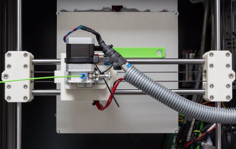 3d printer with bright green filament. 3d printer with bright green filament.