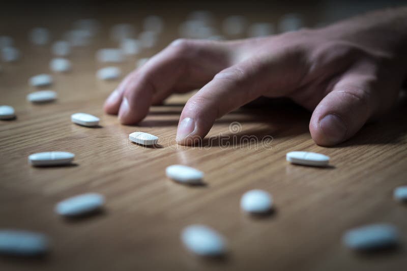 Drug addict with withdrawal symptoms lying on floor. stock photos Drug addict with withdrawal symptoms lying on floor. stock photos
