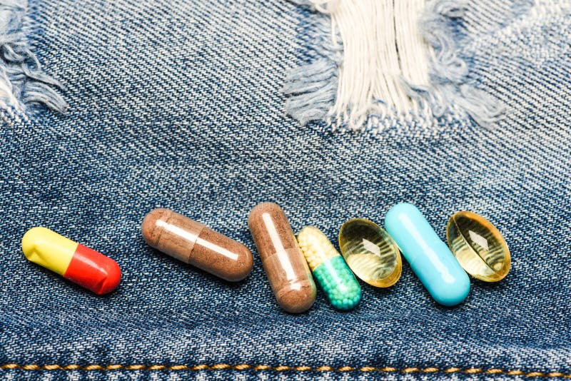 Drugs on denim background. Set of colorful pills. Mixing medicines. Fast treatment. Medicine prescription. Health care royalty free stock photos Drugs on denim background. Set of colorful pills. Mixing medicines. Fast treatment. Medicine prescription. Health care royalty free stock photos