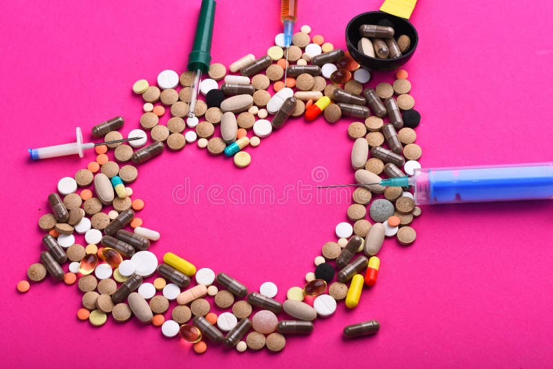 Drugs near syringes, pipette and measuring spoon. Set of colorful pills scattered on pink background, copy space. Frame made of pills and capsules put in shape of heart. Medicine and love concept. Drugs near syringes, pipette and measuring spoon. Set of colorful pills scattered on pink background, copy space. Frame made of pills and capsules put in shape of heart. Medicine and love concept