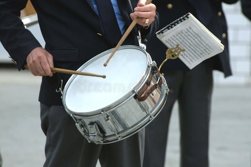 Uniform musician playing traditional drum. Uniform musician playing traditional drum