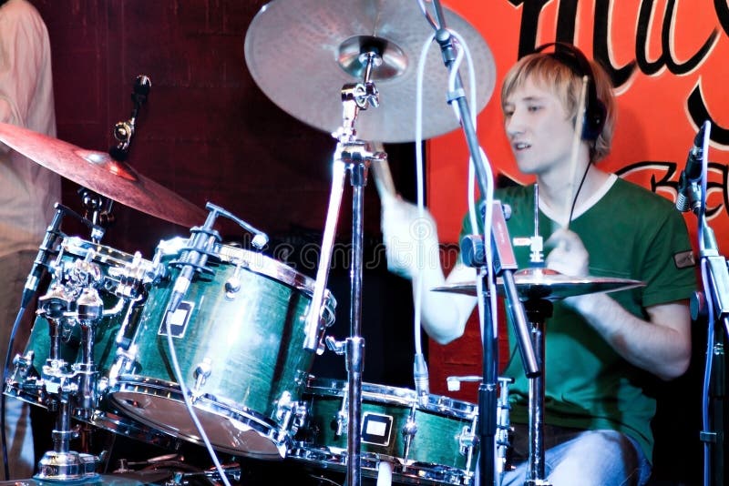 Drummer in green t-shitr plaing music. Drummer in green t-shitr plaing music