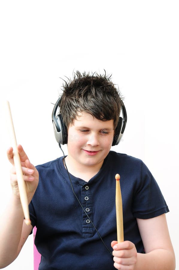 Shot of a boy with headphones and drumsticks. Shot of a boy with headphones and drumsticks